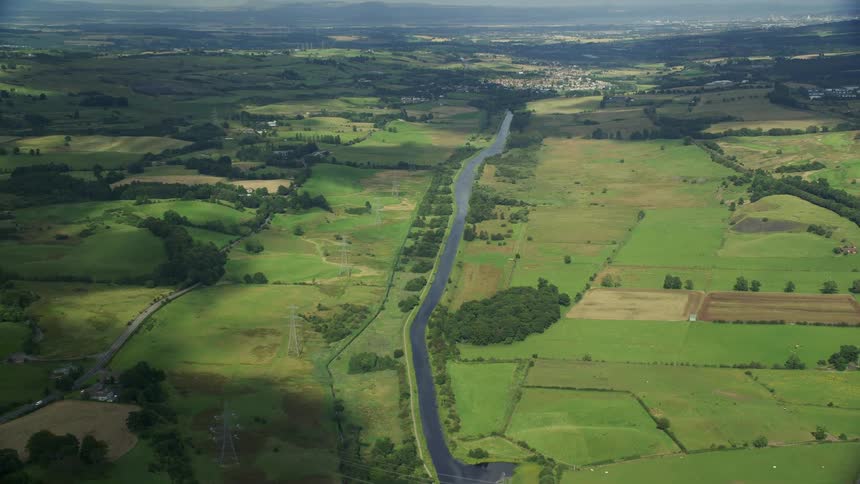 Aerial of a river through the farmland at daytime