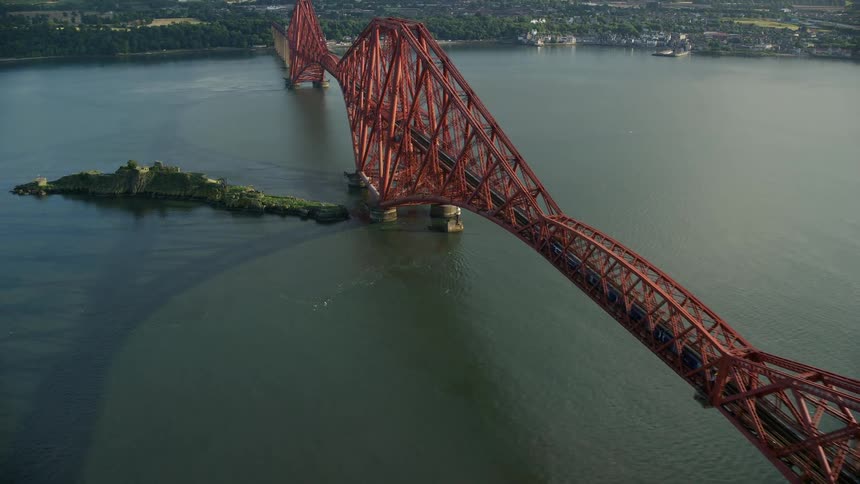 Huge bridge spanning across the sea with vehicles and a train passing through