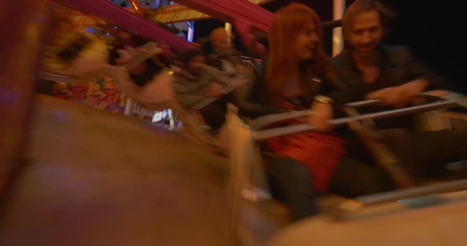 People on an amusement park ride going backwards