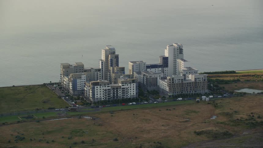 Aerial view of an apartment complex next to the ocean
