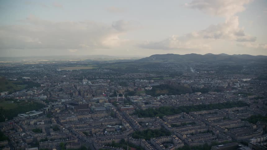 Aerial view of an urban area with a mountain range in the background
