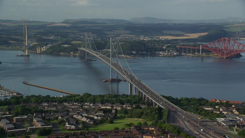A coastal town with a huge river running through it and a bridge crossing the grounds