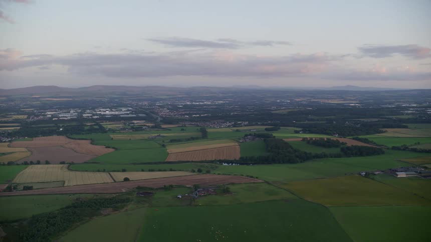 Aerial view of a rural area with an urban city in the background