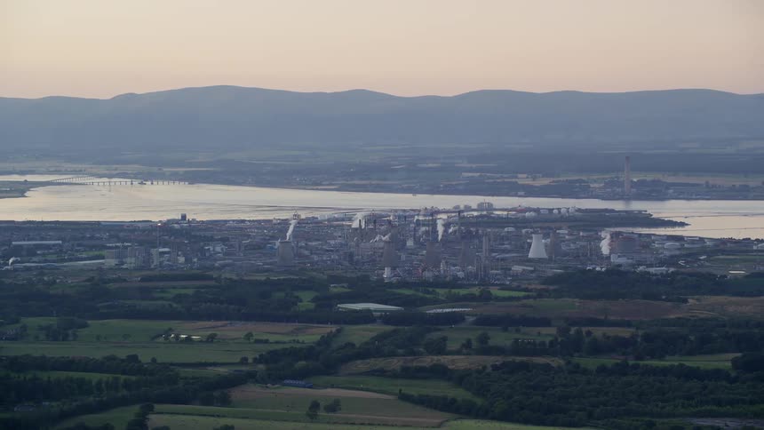 An aerial view of a city next to a river and a rural part