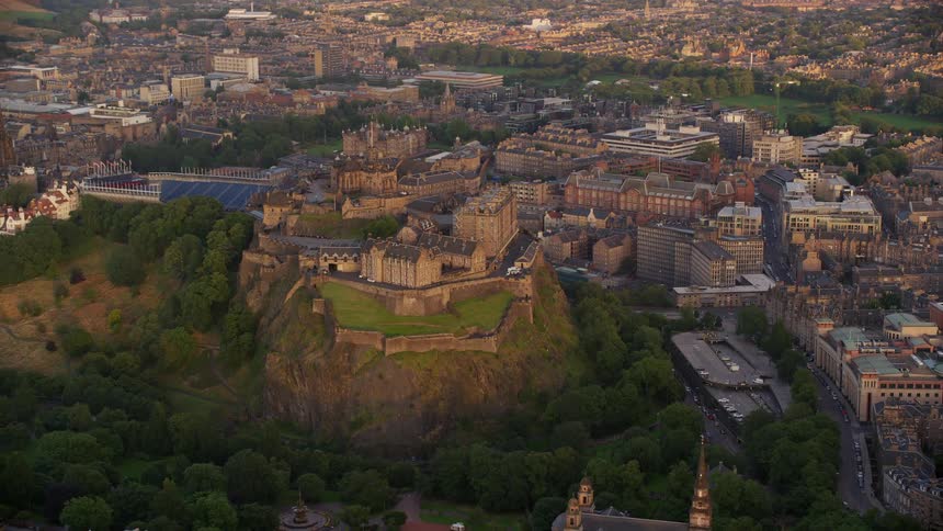 Aerial view of a public place built on top of a mountain with a city and vegetation around it