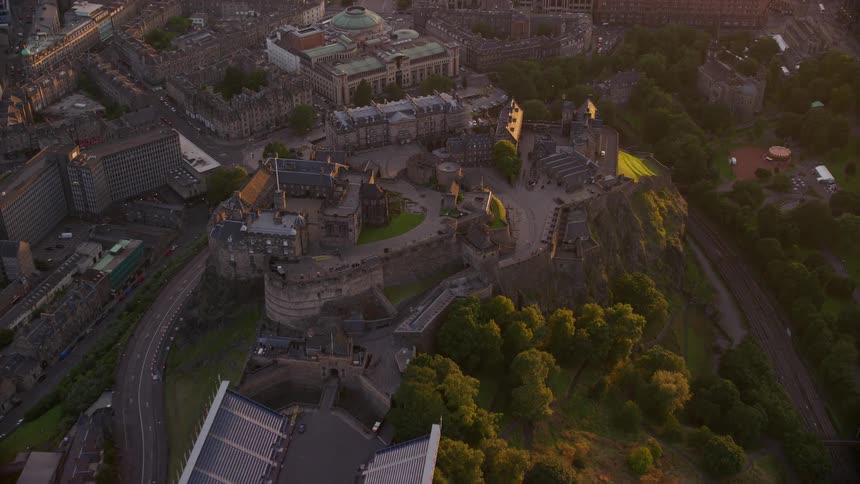 Aerial view of a public area in the middle of the city with buildings and the sunset in the background
