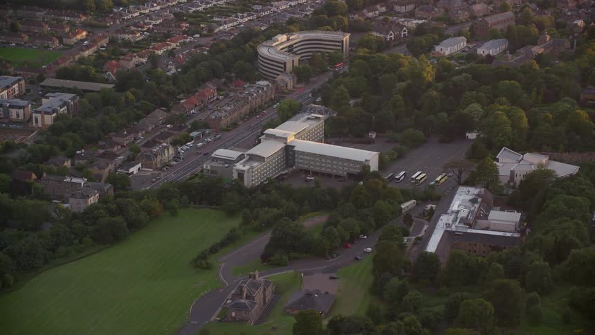 Aerial view of an urban area with fields public places during a late afternoon
