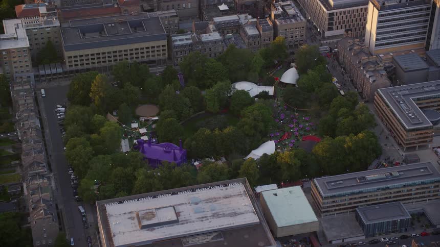 Aerial of a music festival in a metropolitan city during sunset