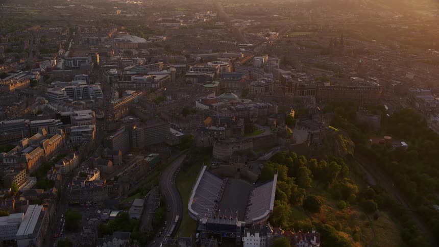 An aerial view of a metropolitan city with many buildings being illuminated by morning sunlight