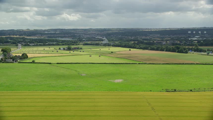 Aerial view of agricultural fields with a small town in the background