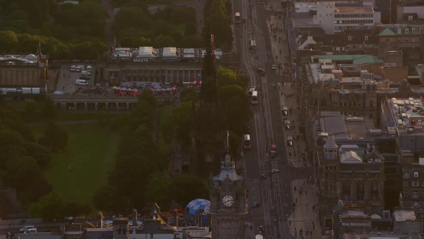 Aerial view of a city with public places a ferris wheel during a late afternoon