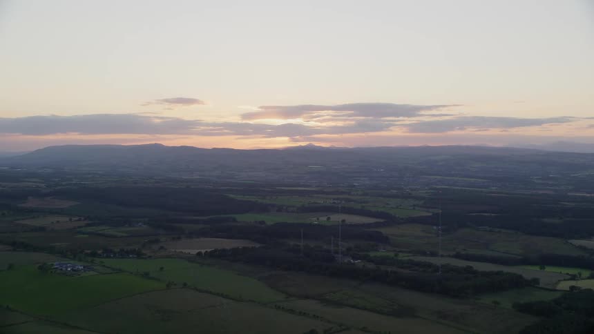 Aerial view of farm fields in the countryside at sunset