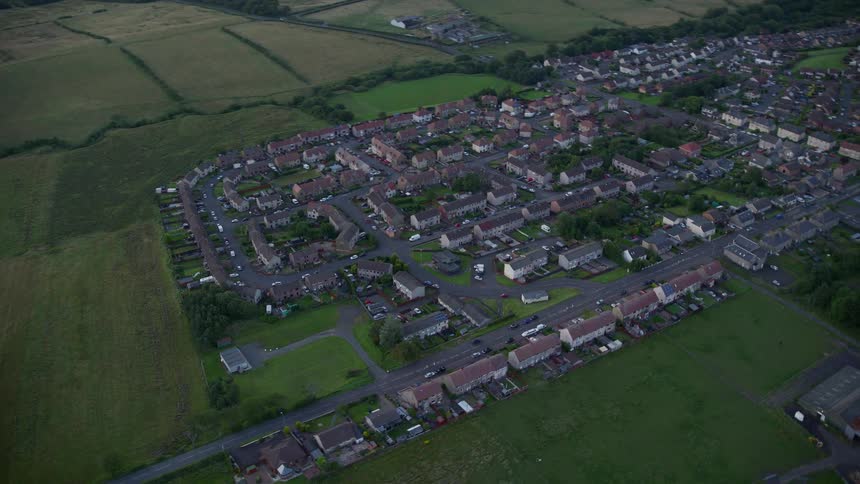 Aerial view of a residential area by the edge of a pasture