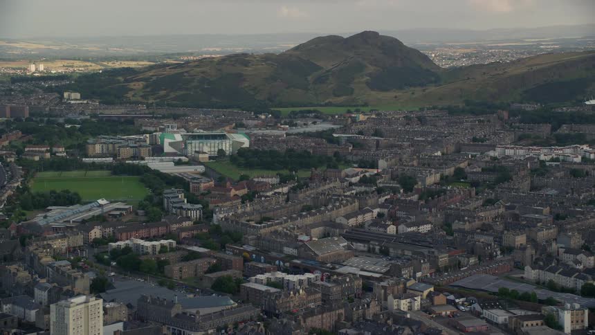 An aerial view of a metropolitan city that is next to mountains