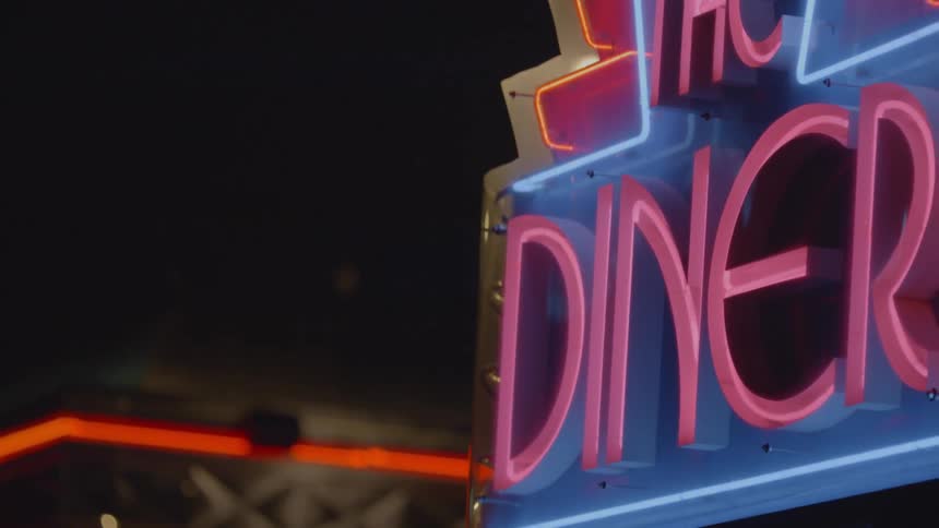 A diner light is on at night