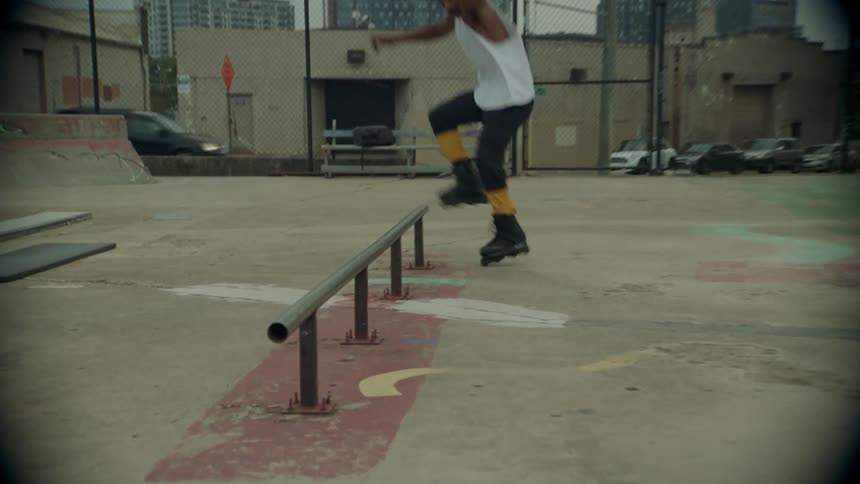 A man on roller skates doing tricks on a handrail