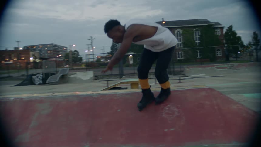 A man doing tricks on a roller skate at the skate park