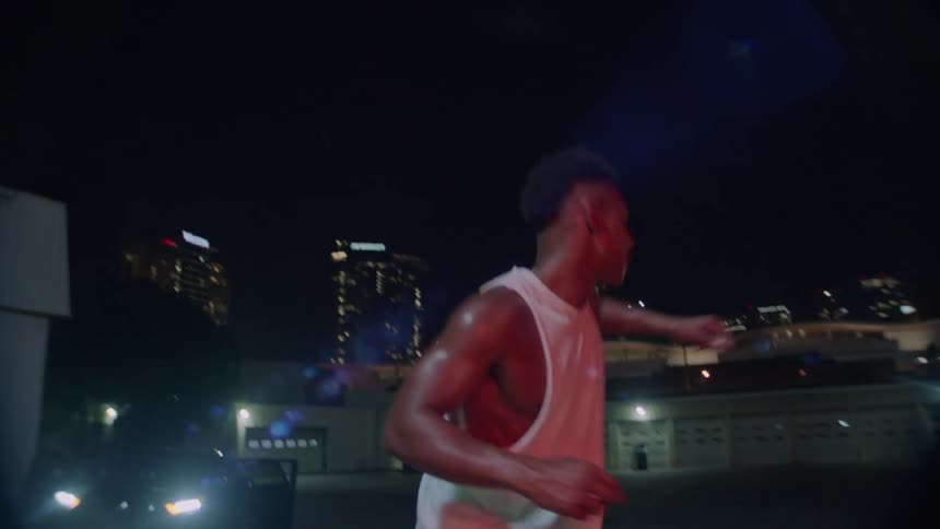 A man dancing on roller skates in a parking lot