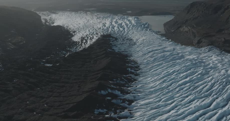 Aerial of a frozen lake with brown mountains around