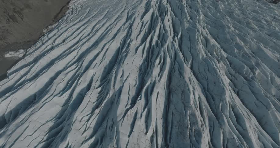 Aerial of a frozen sea with brown mountains around