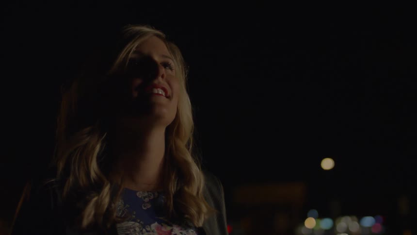 Blonde Woman Watches Fireworks at Night