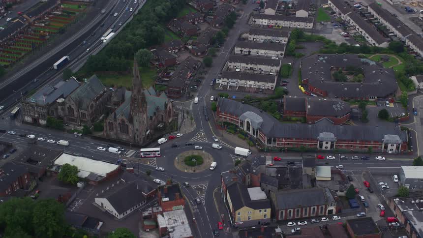 Aerial view of a city with roads and vehicles moving