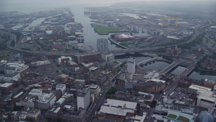 Aerial of buildings and roads in a metropolitan area at sunset