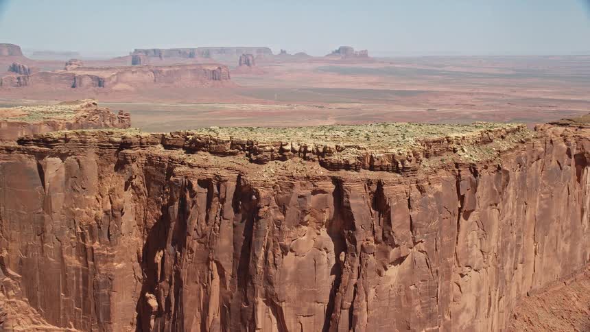 Land with lake separates plateau topped formations