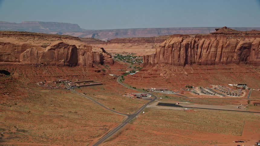 Aerial view of roads next to mountains and mesas on the badlands