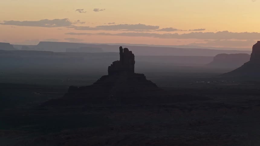 Aerial view of a natural environment with a canyon and a reddish sky