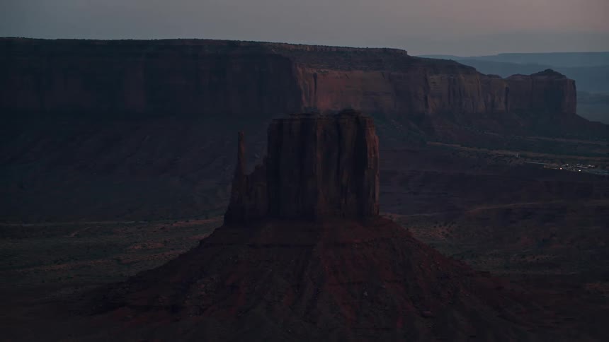 Red rock formation and plateau at dusk