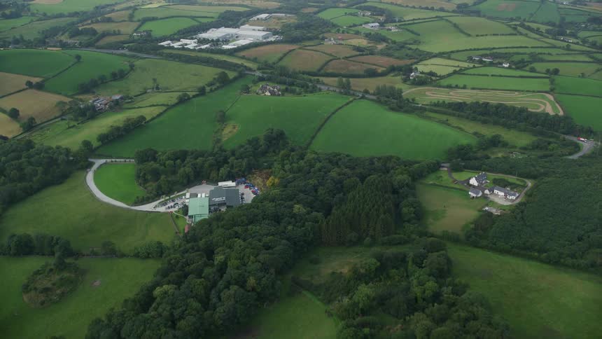 Aerial view rural pastures and scattered buildings