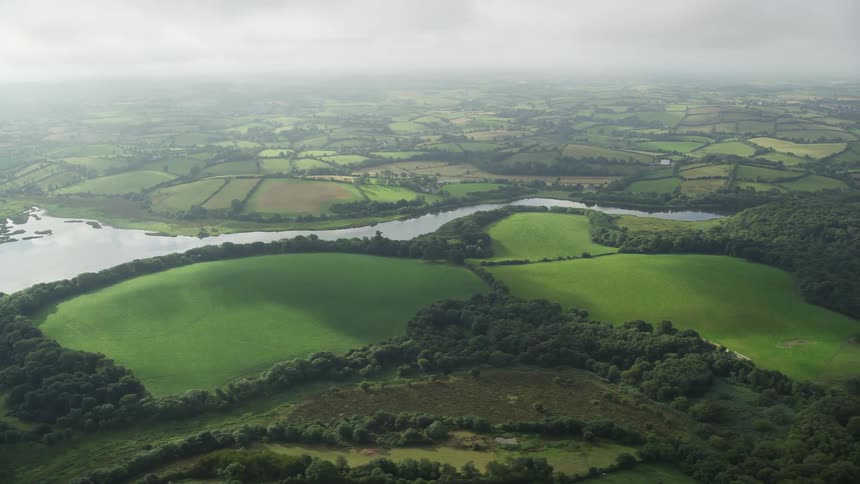 Aerial view of a river flowing through farm fields