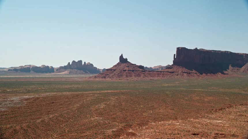 Aerial view of rock formation in the distance in the desert