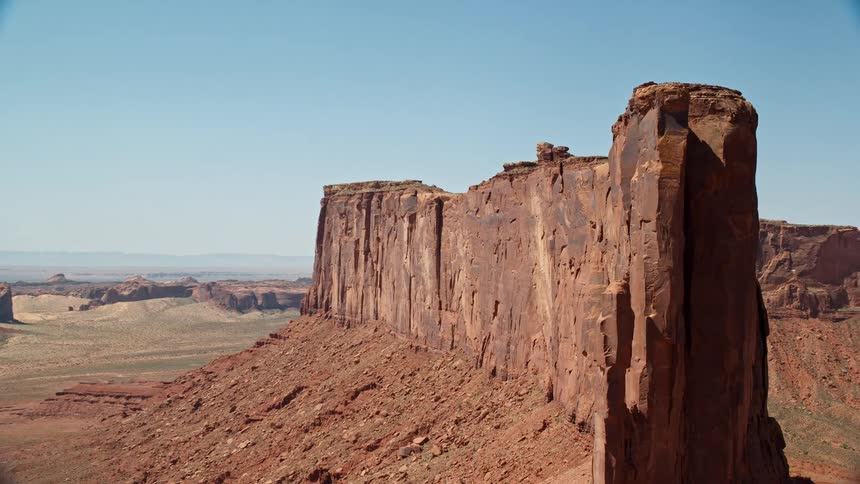 Aerial view of mountainous desert landscape with a prominent rock formation