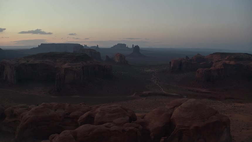 Aerial view of mountains and mesas on the badlands at sunset