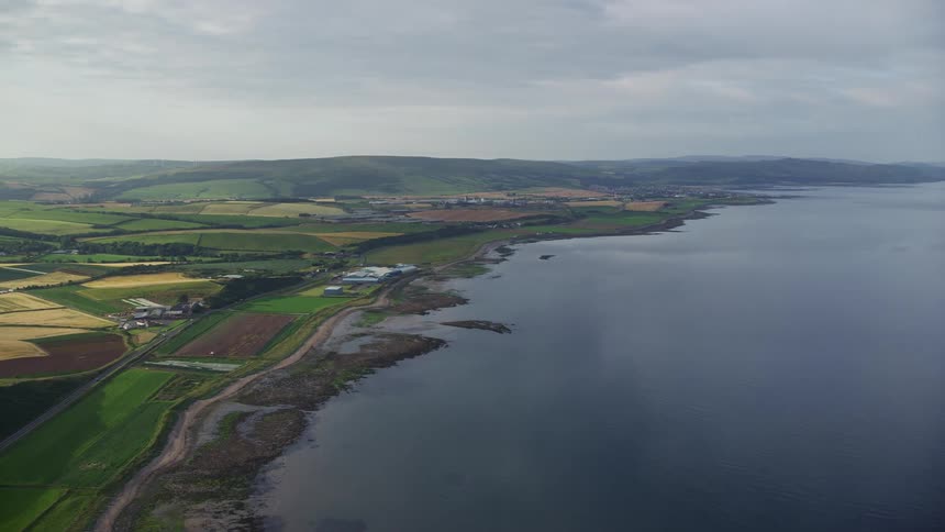 Rural area with extensive pasture a highway alongside and by the seaside
