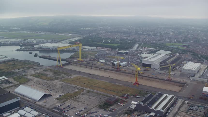 Yellow crane near waterway andbuildings