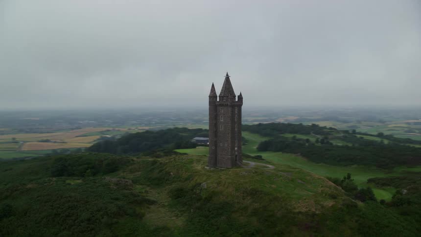 Aerial of a mountain with a castle with turrets and nature