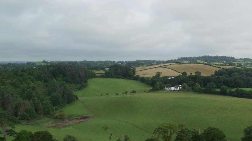 Aerial view of a house in a green hill in the countryside