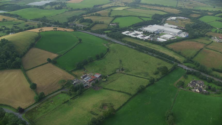 Aerial view of green fields and pastures in rural community