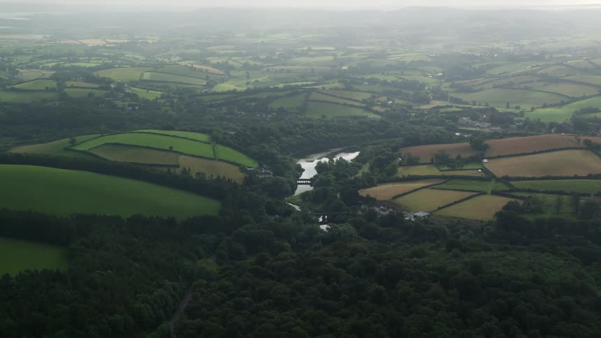 Aerial view of a rural area with some residences forest and a lake