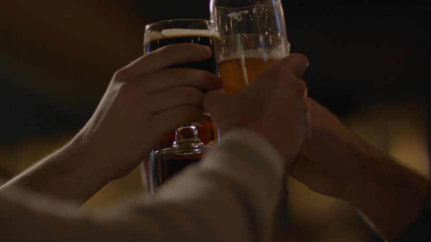 People toast their glasses together