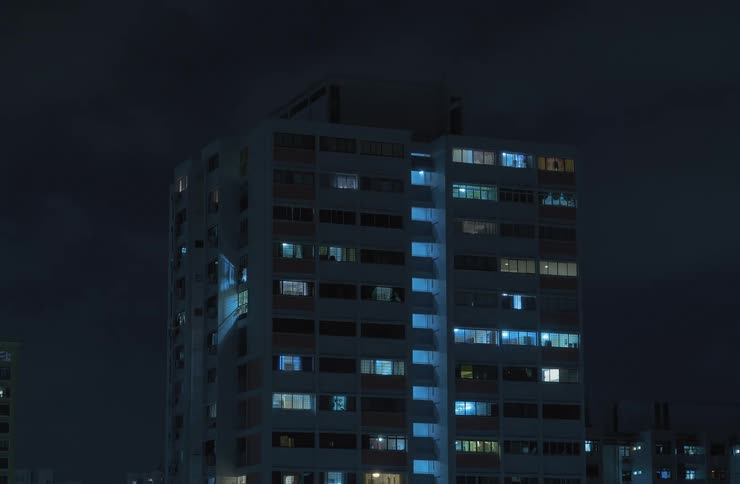 Timelapse of a residential building turning off all its lights during the night
