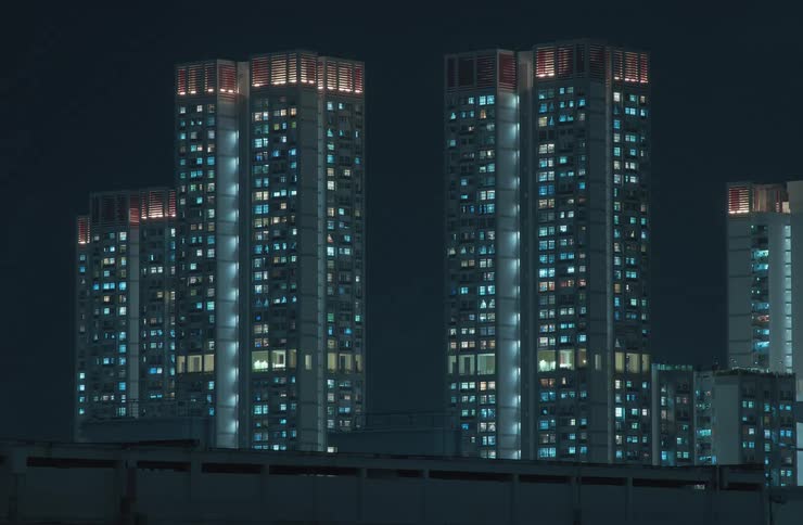 Urban buildings with residential lights gradually turning off throughout the night