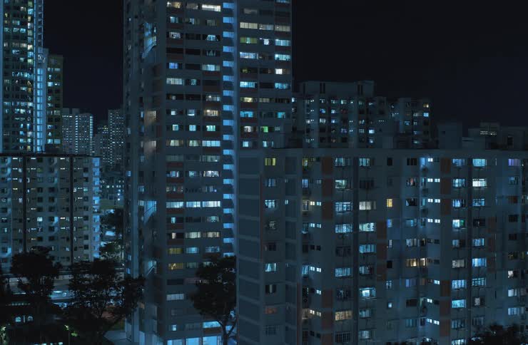 Residential buildings have their apartment lights turned off during the course of the night