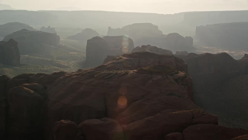 Aerial view of the plateaus rising amidst the vast desert at sunrise