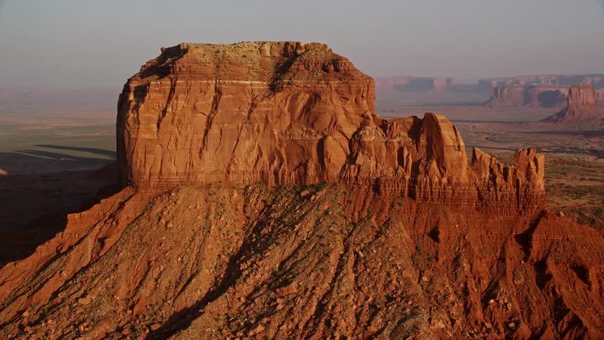 Aerial view of a natural reserve with valleys and canyons featuring rocky and geological formations during the late afternoon sun