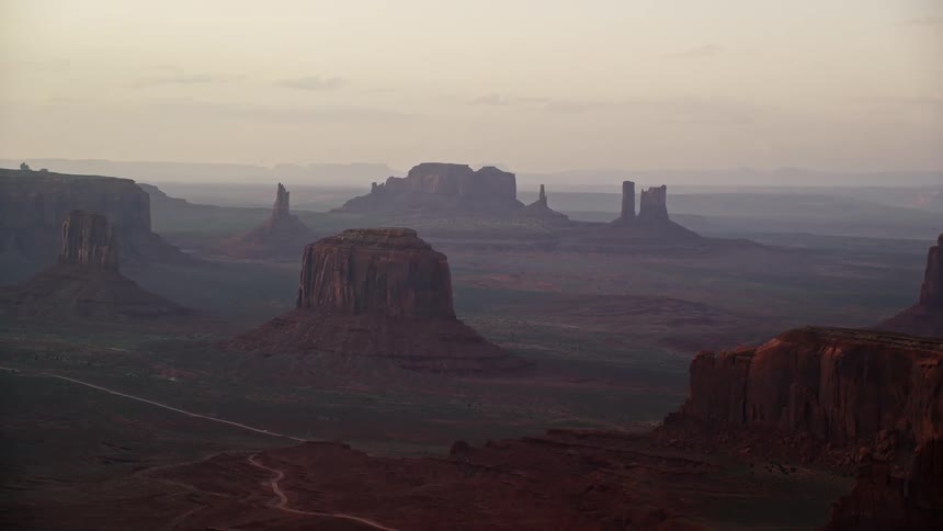 Aerial view of the plateaus rising amidst the vast desert at dawn