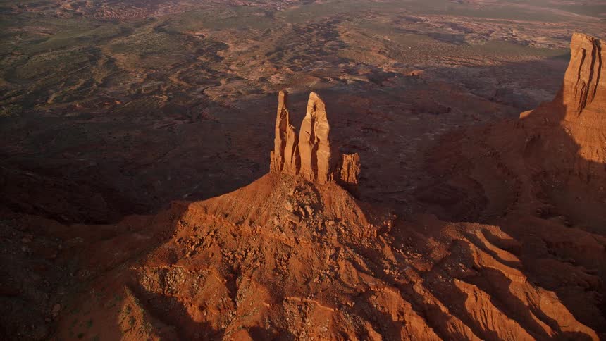 A large natural stone tower formed in the desert